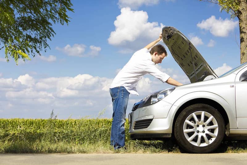 Man inspecting vehicle engine under the hood car on the side of the road stops working, auto computer repair