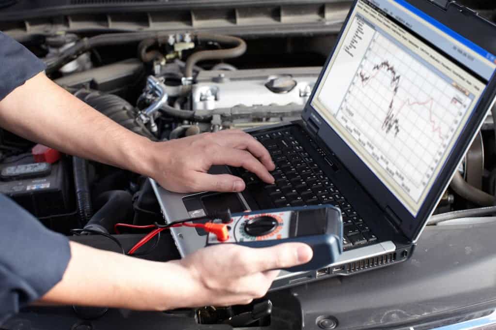 Man fixing car ECM computer