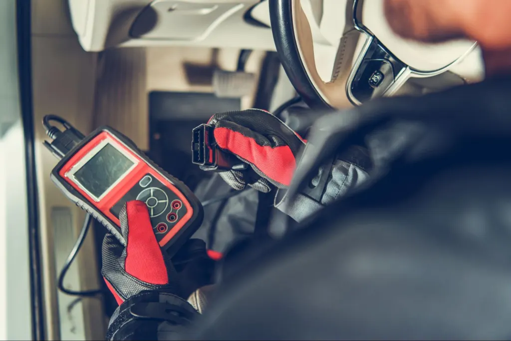 Man checking the car TCM to restore communication with an OBD